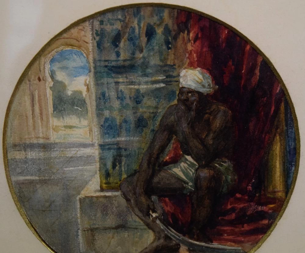 Uomo arabo seduto con una lunga spada